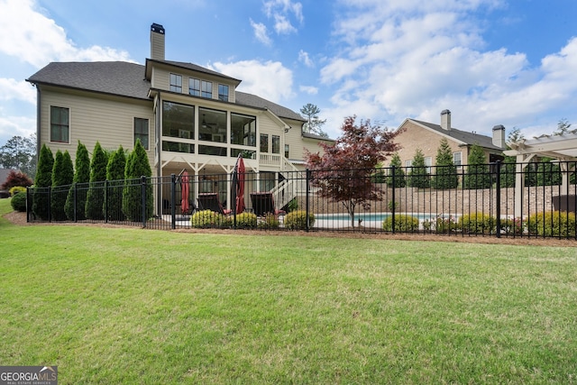 back of property with a chimney, roof with shingles, and a ceiling fan