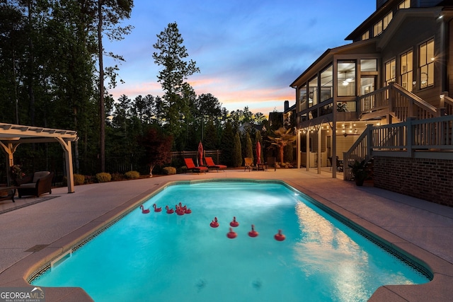 outdoor pool with a patio, stairs, and a pergola