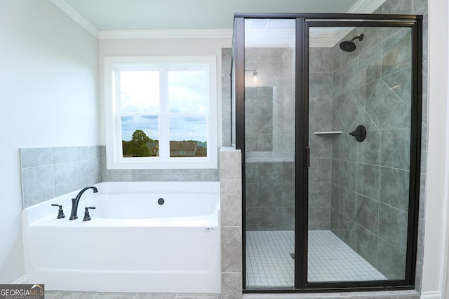 457 Banff Dr, Winder, GA 30680 - bathroom featuring a garden tub, a shower stall, and crown molding