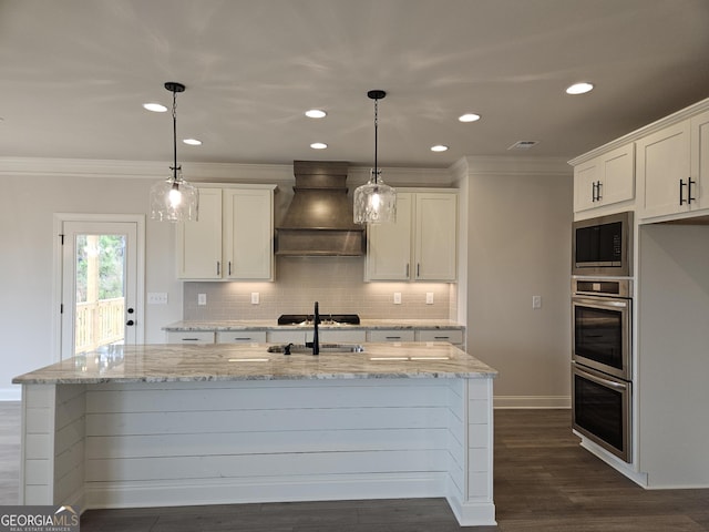 457 Banff Dr, Winder, GA 30680 - kitchen with premium range hood, stainless steel double oven, built in microwave, ornamental molding, and a sink