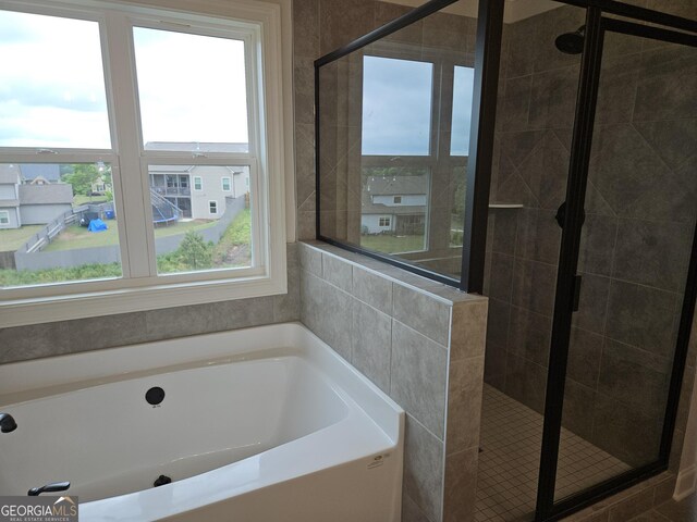 457 Banff Dr, Winder, GA 30680 - bathroom with a stall shower and a garden tub