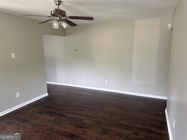 1685 Pheasant Dr, Jonesboro, GA 30238 - spare room with a textured ceiling, ceiling fan, dark wood-style floors, and baseboards
