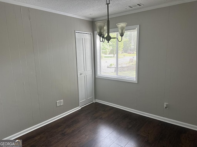 1685 Pheasant Dr, Jonesboro, GA 30238 - unfurnished dining area with crown molding, visible vents, dark wood-style flooring, a textured ceiling, and a notable chandelier