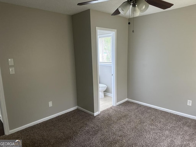 1685 Pheasant Dr, Jonesboro, GA 30238 - unfurnished bedroom with carpet floors, a ceiling fan, baseboards, and ensuite bathroom