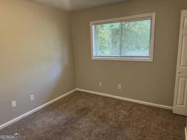 1685 Pheasant Dr, Jonesboro, GA 30238 - spare room with baseboards and carpet