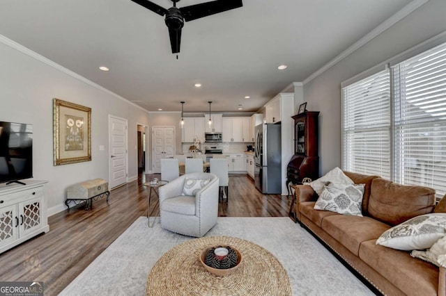 5299 Noble Village Way, Lilburn, GA 30047 - living room featuring a ceiling fan, wood finished floors, baseboards, ornamental molding, and recessed lighting