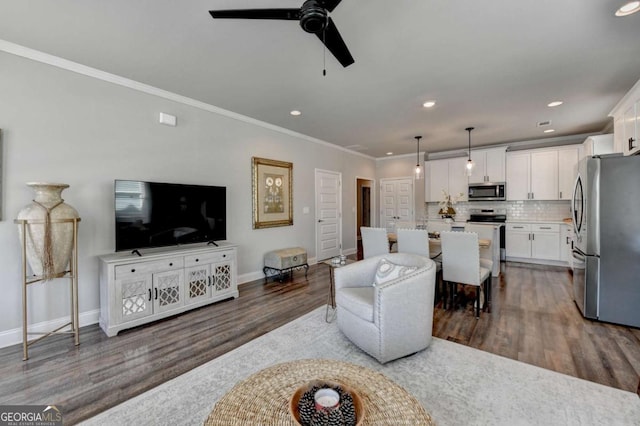 5299 Noble Village Way, Lilburn, GA 30047 - living area featuring ceiling fan, baseboards, dark wood-style floors, ornamental molding, and recessed lighting