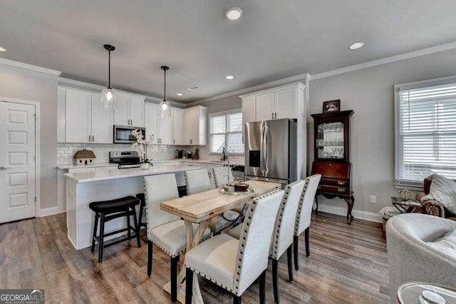 5299 Noble Village Way, Lilburn, GA 30047 - dining room with baseboards, recessed lighting, crown molding, and wood finished floors