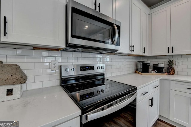 5299 Noble Village Way, Lilburn, GA 30047 - kitchen featuring light countertops, decorative backsplash, white cabinets, and stainless steel appliances