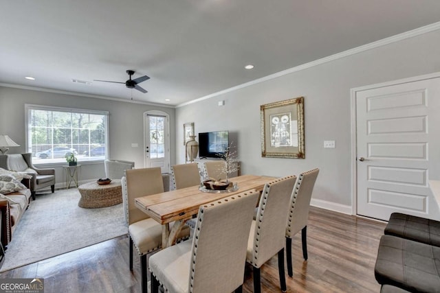 5299 Noble Village Way, Lilburn, GA 30047 - dining area with baseboards, a ceiling fan, dark wood finished floors, and ornamental molding