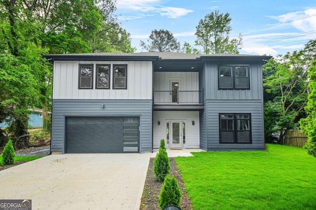 view of front facade featuring a garage, fence, a balcony, a front yard, and driveway