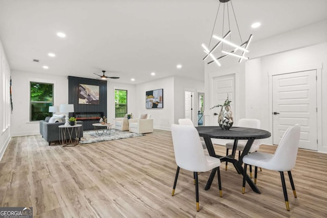 dining space with recessed lighting, baseboards, wood finished floors, and ceiling fan with notable chandelier