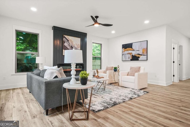 living room with baseboards, recessed lighting, ceiling fan, and wood finished floors