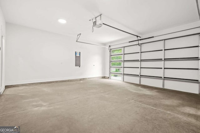 garage featuring recessed lighting, baseboards, a garage door opener, and electric panel