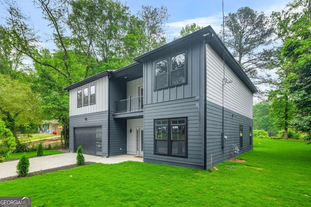 921 Cone Rd, Forest Park, GA 30297 - view of front facade featuring a balcony, board and batten siding, an attached garage, a front yard, and concrete driveway