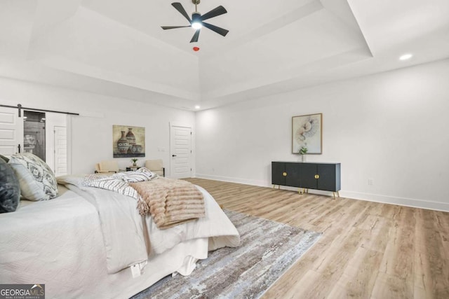 921 Cone Rd, Forest Park, GA 30297 - bedroom featuring a raised ceiling, wood finished floors, a barn door, recessed lighting, and ceiling fan