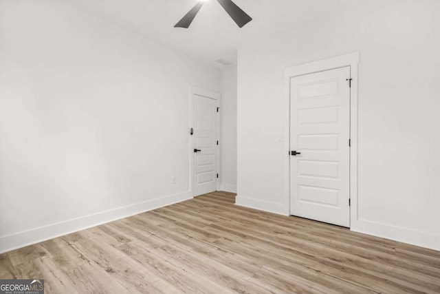 unfurnished bedroom with baseboards, ceiling fan, and light wood-style flooring