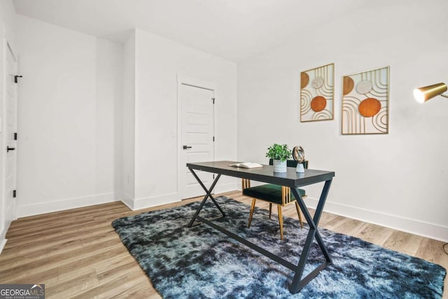 office featuring baseboards and wood finished floors