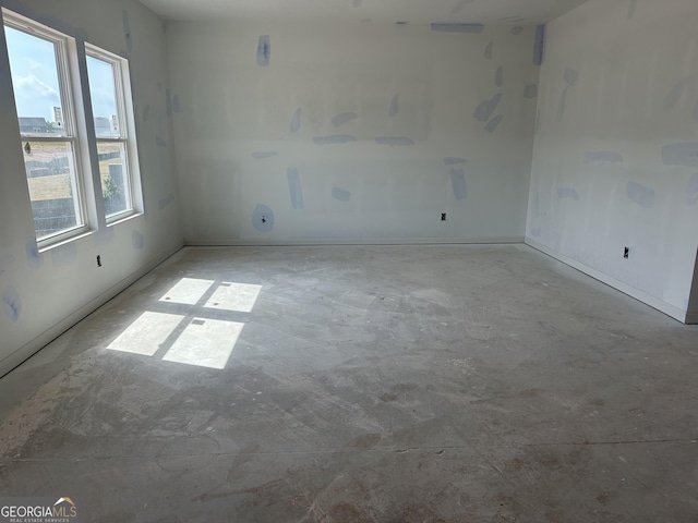 spare room with concrete floors