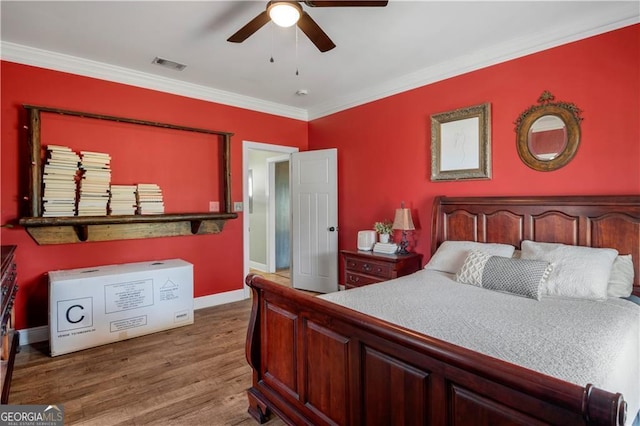 3224 Ware St, Blackshear, GA 31516 - bedroom with a ceiling fan, baseboards, wood finished floors, visible vents, and ornamental molding