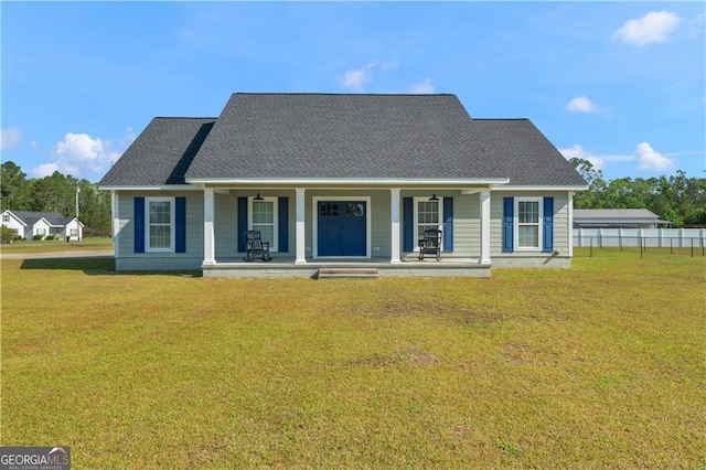 3224 Ware St, Blackshear, GA 31516 - view of front facade featuring a porch, roof with shingles, fence, and a front yard