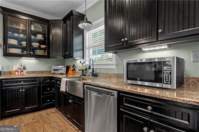 3224 Ware St, Blackshear, GA 31516 - kitchen with dark cabinets, ornamental molding, light stone counters, and stainless steel appliances