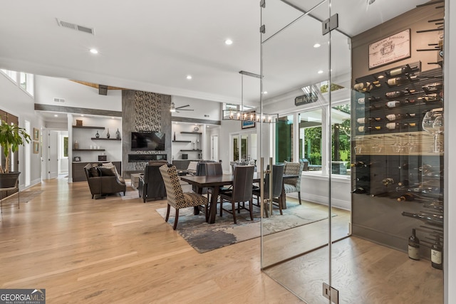 dining room with light wood-style floors, a ceiling fan, recessed lighting, and visible vents