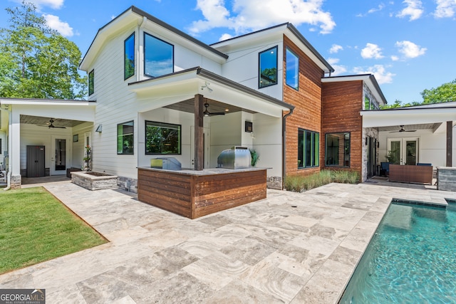 back of property featuring a patio, ceiling fan, outdoor lounge area, and exterior kitchen