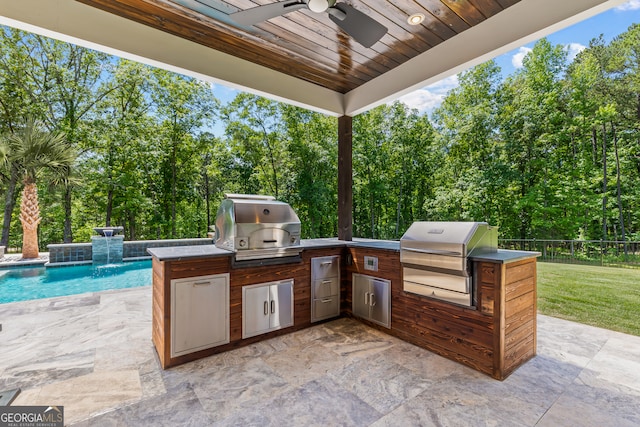 view of patio with grilling area, exterior kitchen, and ceiling fan