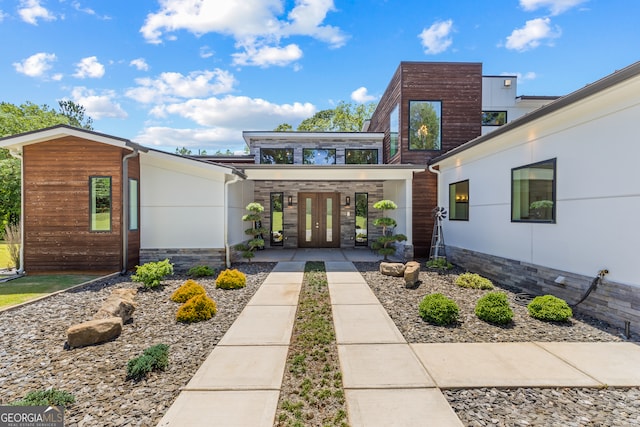 view of front of property featuring french doors and stone siding