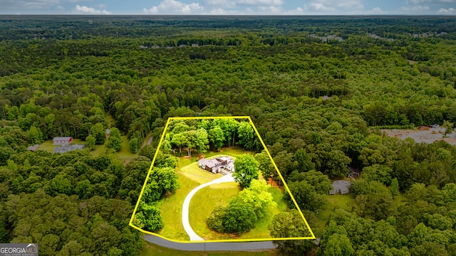 birds eye view of property featuring a view of trees
