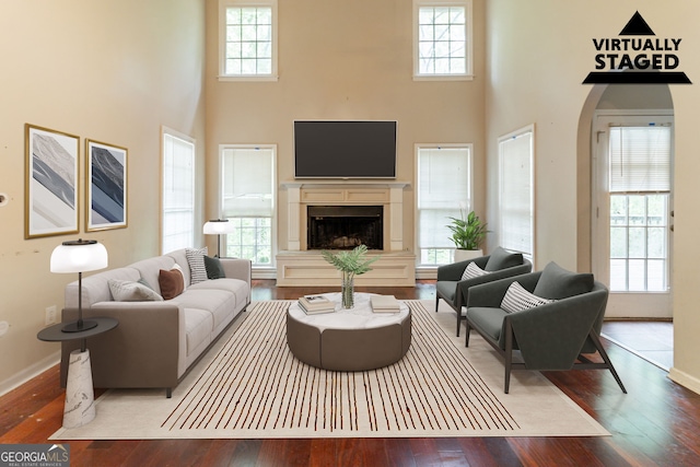 6416 Vicksburg Ct NW, Acworth, GA 30101 - living area featuring wood-type flooring, a towering ceiling, and plenty of natural light