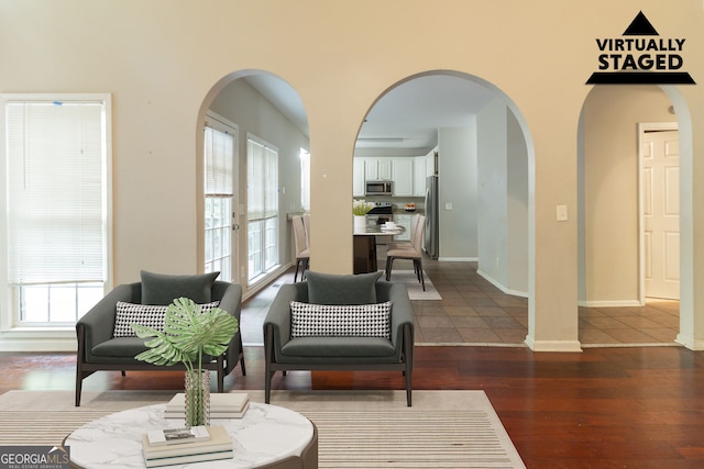 6416 Vicksburg Ct NW, Acworth, GA 30101 - living area with arched walkways, dark wood-type flooring, healthy amount of natural light, and baseboards