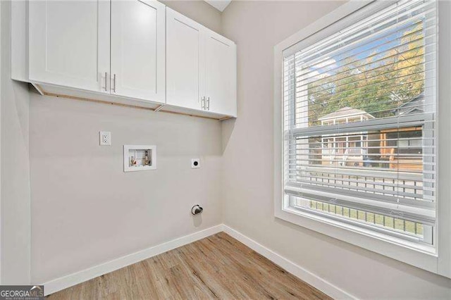 962 Welch St SW, Atlanta, GA 30310 - clothes washing area with washer hookup, electric dryer hookup, cabinet space, baseboards, and light wood-style flooring