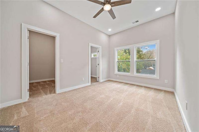 962 Welch St SW, Atlanta, GA 30310 - unfurnished bedroom with a walk in closet, baseboards, carpet flooring, and visible vents