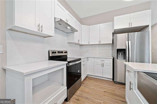 962 Welch St SW, Atlanta, GA 30310 - kitchen with tasteful backsplash, light countertops, under cabinet range hood, stainless steel appliances, and white cabinetry