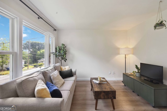 living area featuring baseboards and light wood-style floors