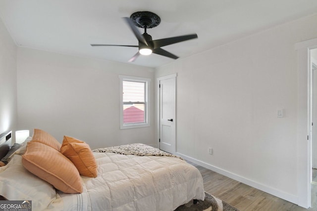 bedroom featuring baseboards, ceiling fan, and light wood-type flooring