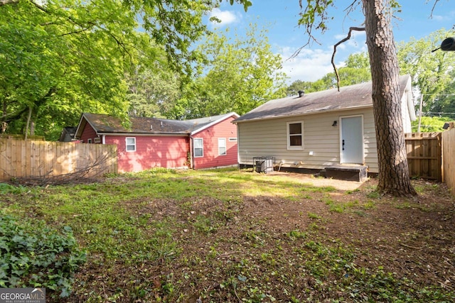 rear view of property featuring fence