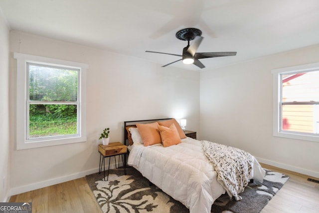 bedroom featuring baseboards, a ceiling fan, and wood finished floors