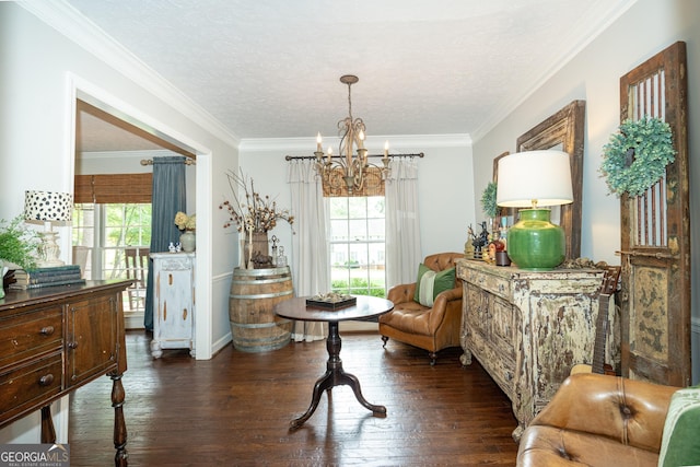 sitting room featuring an inviting chandelier, ornamental molding, wood-type flooring, and a wealth of natural light