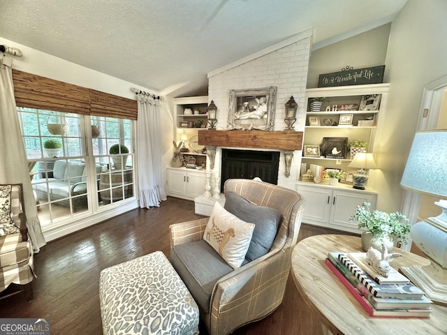 living area featuring a textured ceiling, built in features, a fireplace, vaulted ceiling, and wood finished floors