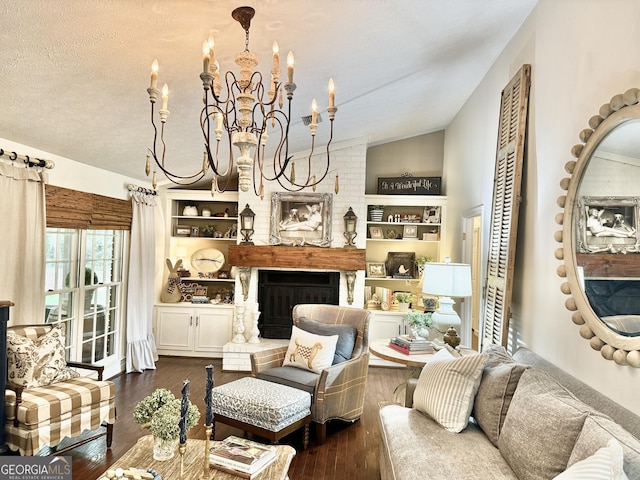 living area featuring a fireplace, a textured ceiling, a chandelier, dark wood finished floors, and lofted ceiling