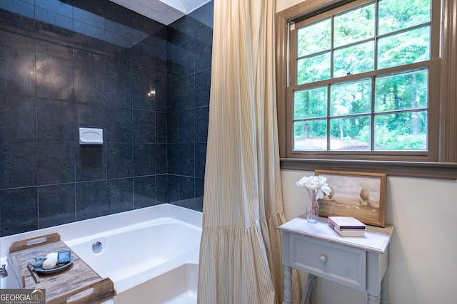 bathroom with shower / tub combo with curtain and a wealth of natural light