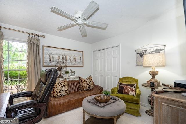 living area featuring ceiling fan and carpet flooring