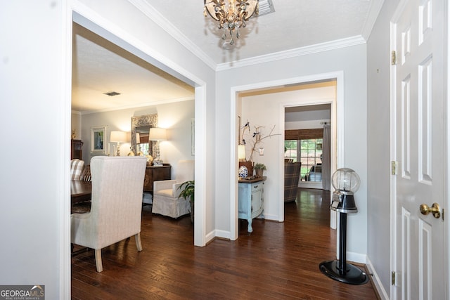 entryway featuring crown molding, baseboards, a notable chandelier, and dark wood-type flooring