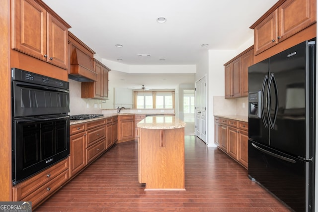 6732 Chimney Ridge Ct, Hoschton, GA 30548 - kitchen with black appliances, a peninsula, dark wood-type flooring, a kitchen island, and recessed lighting