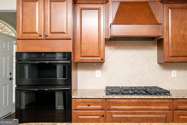 6732 Chimney Ridge Ct, Hoschton, GA 30548 - kitchen with premium range hood, stainless steel gas stovetop, backsplash, and light stone counters
