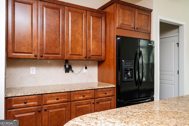 6732 Chimney Ridge Ct, Hoschton, GA 30548 - kitchen with black fridge with ice dispenser, backsplash, and brown cabinetry