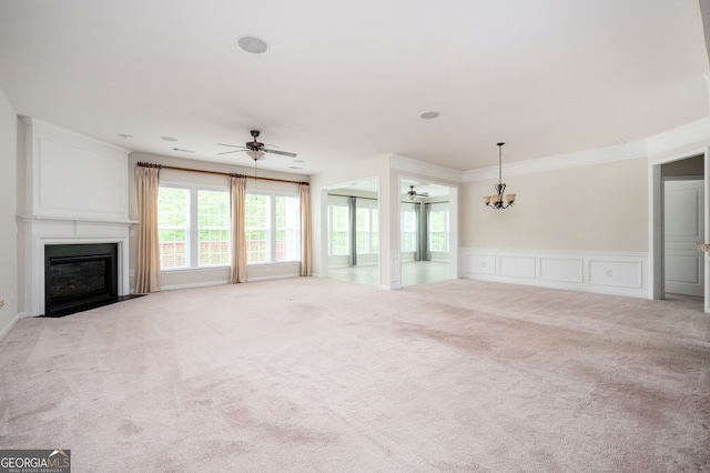 6732 Chimney Ridge Ct, Hoschton, GA 30548 - unfurnished living room featuring light colored carpet, ceiling fan, a fireplace with flush hearth, a chandelier, and a decorative wall